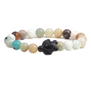 Beaded bracelet with turquoise and volcanic stones featuring a black turtle charm