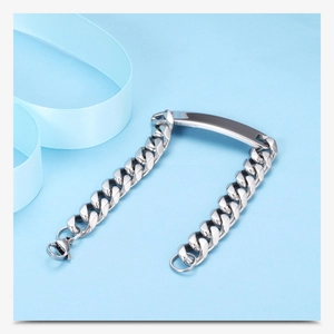 Macro shot of silver stainless steel 11mm Cuban chain bracelet with blank metal nameplate
