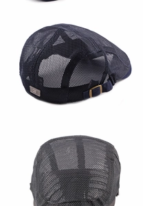 Detailed view of dark blue breathable mesh beret with adjustable bronze buckle and S logo