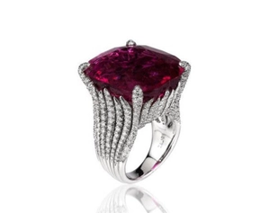 Luxury cushion cut ruby ring with diamond accents and feather pattern on a white background