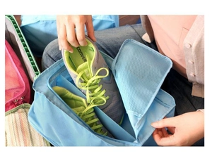 Detail of light blue waterproof shoe bag with breathable mesh window and zipper closure