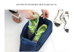 Detail view of a navy waterproof shoe bag showing mesh pockets and spacious interior compartment