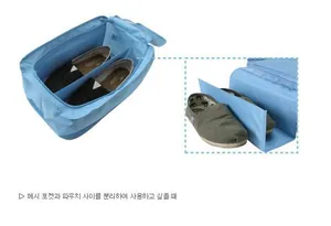 Detail view of light blue travel shoe bag with internal divider and dual compartments