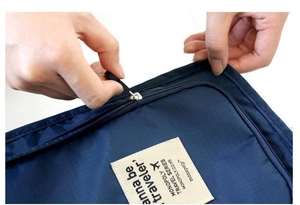 Detail of durable nylon travel shoe bag with metal zipper and woven brand label