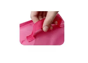 Close-up of pink portable shoe storage bag with durable woven handle for travel organization