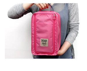 Close-up of rose pink waterproof travel shoe bag with handle and zipper detail