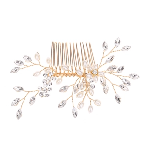 Detail of handmade gold hair comb with elegant pearls and sparkling clear crystals