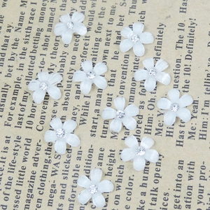 White five-petal resin cherry blossom charms with center rhinestones for DIY crafts