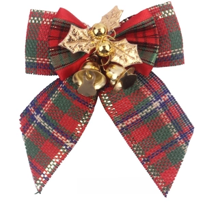 Close-up of red and green plaid burlap Christmas bow with gold bells and holly leaves