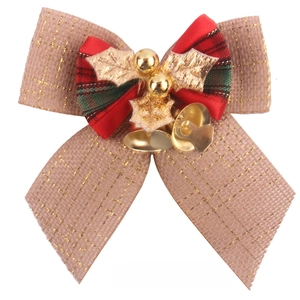 Detailed view of burlap Christmas bow with gold thread and small bells decoration