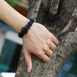 Braided black leather bracelet with metal anchor clasp in a stylish rock-inspired design