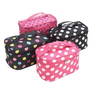 Detail of four PU cosmetic bags with heart and polka dot patterns and dual zippers