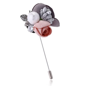 Detail of pink satin rose brooch with lace-textured pearl and silver crystal pin