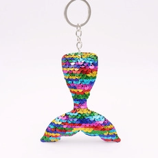 Close-up of vibrant rainbow sequin mermaid tail keychain with silver metal ring