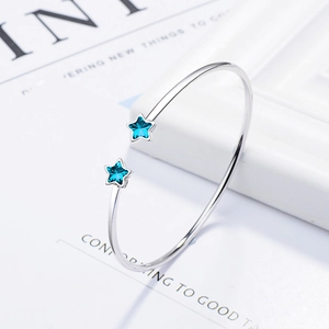 Adjustable silver star open bangle with blue crystals in a minimalist modern style