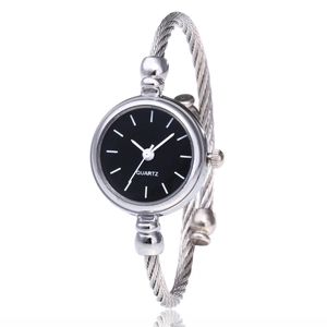 Macro detail of the silver cable twist bracelet watch with a minimalist black quartz dial
