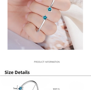 Detail view of silver open bangle with 7mm blue star charms weighing 6 grams
