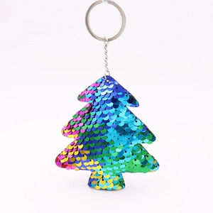 Close-up of colorful sequins on a Christmas tree keychain with silver metal ring