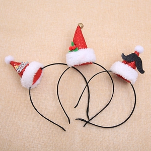 Three assorted Christmas hat headbands with Merry Christmas text and festive ornaments