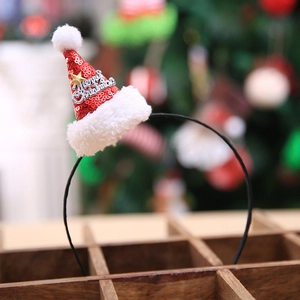 Sparkly red Christmas hat headband with sequins and gold star on a festive background