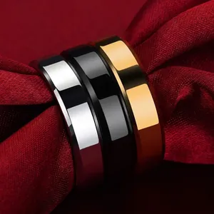 Polished 6mm stainless steel band rings in silver, black, and gold on red silk background
