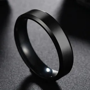 Close-up of a 6mm black matte stainless steel ring with beveled edges and flat surface