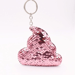 Detail view of a pink sequin poop-shaped keychain with shiny metal ring and chain