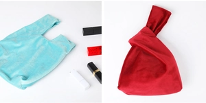 Detail of light blue and deep red velvet wrist bags for gifts and cosmetics