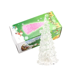 Luminous crystal Christmas tree night light with festive green gift box on white background