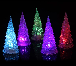 Macro detail of LED glowing crystal Christmas trees in multiple vibrant neon colors