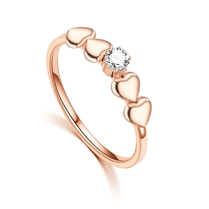 Detailed close-up of rose gold heart ring featuring a central sparkling zircon stone