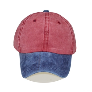 Detailed front view of vintage washed cotton baseball cap with red crown and blue brim