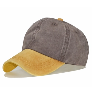 Detail of vintage washed cotton baseball cap with grey crown and yellow brim contrast