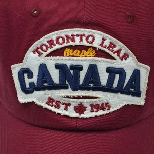 Detailed close-up of Canada embroidery and maple leaf on cotton baseball cap
