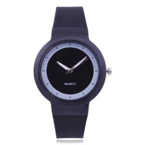 Close-up of a minimalist black quartz watch with silicone strap and white dial markers