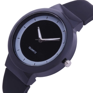 Macro shot of a minimalist black quartz watch dial with silver hands and resin strap