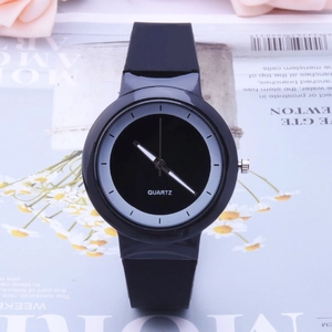 Close-up of minimalist black silicone jelly quartz watch on floral magazine background