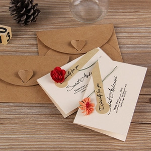 Flat lay of vintage kraft envelopes and greeting cards decorated with dried flowers