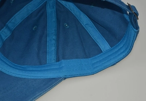 Detailed interior of washed cotton baseball cap with sweatband and metal buckle