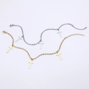 Minimalist gold and silver titanium steel anklets with cross pendants on white background