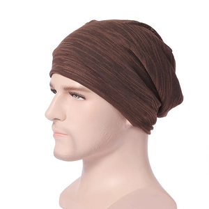 Close-up of dark brown knit beanie showing detailed ribbed texture and flexible fabric