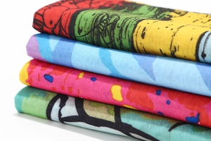 Close-up of stacked seamless multi-use headwear with diverse colorful patterns and textures