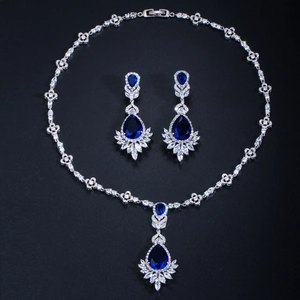 Macro shot of silver bridal jewelry set with blue teardrop and white marquise stones