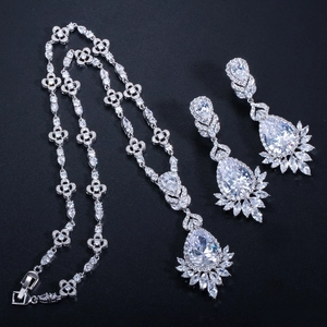 Close-up of bridal jewelry set with pear-shaped cubic zirconia and clover pattern