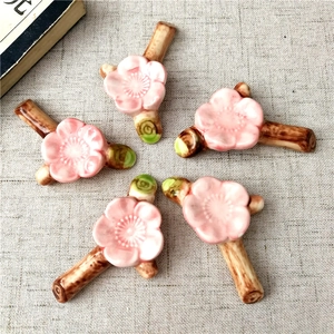 Japanese style pink cherry blossom ceramic chopstick rests set of five on linen cloth