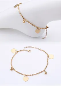 Detailed view of a gold heart anklet with solid heart charms and polished beads