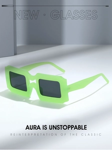 Detail view of bold neon green square sunglasses with thick frames and dark lenses