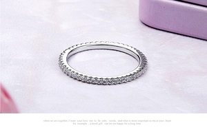 Macro shot of a minimalist S925 sterling silver eternity ring with pavé set zircons