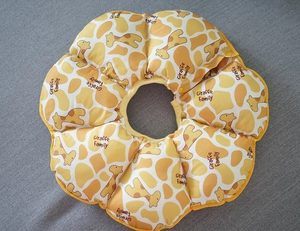 Detailed top view of soft giraffe print sunflower E-collar with adjustable snap button
