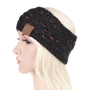 Close-up of black knitted headband with colorful flecks and brown C.C leather patch